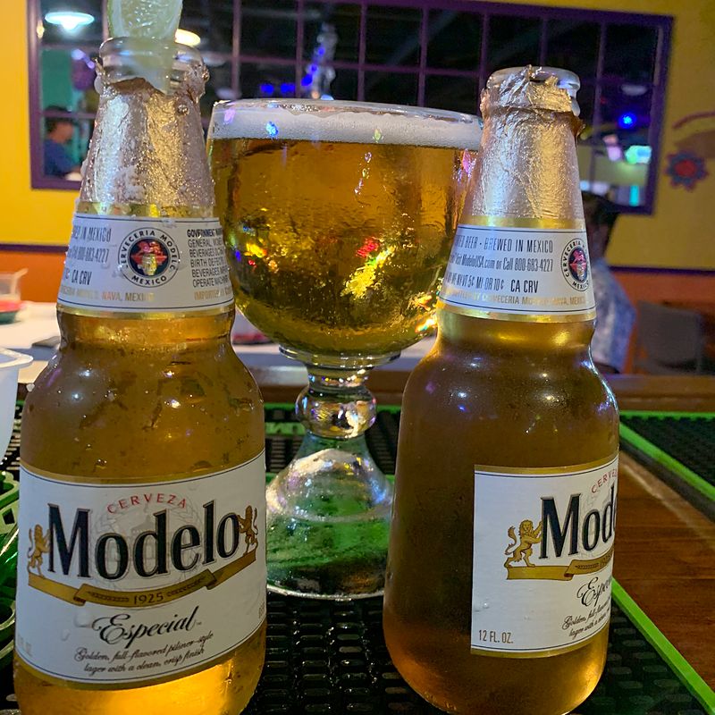Modelo Especial bottles and a draft beer on the bar