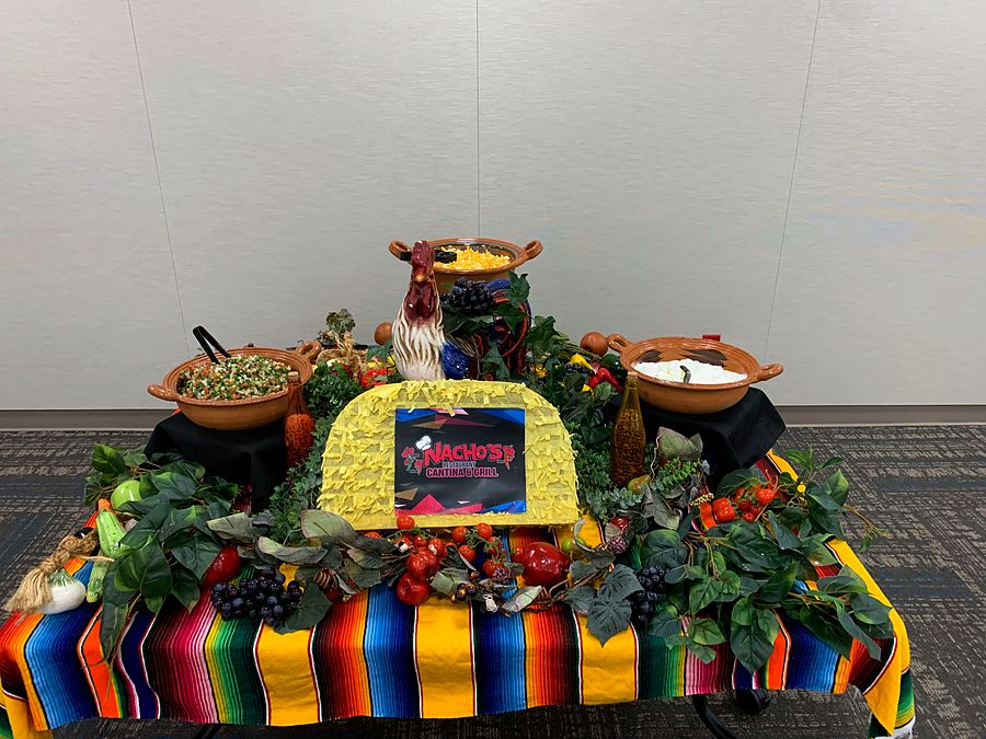 A Nacho's Cantina & Grill catering spread with the restaurant's sign