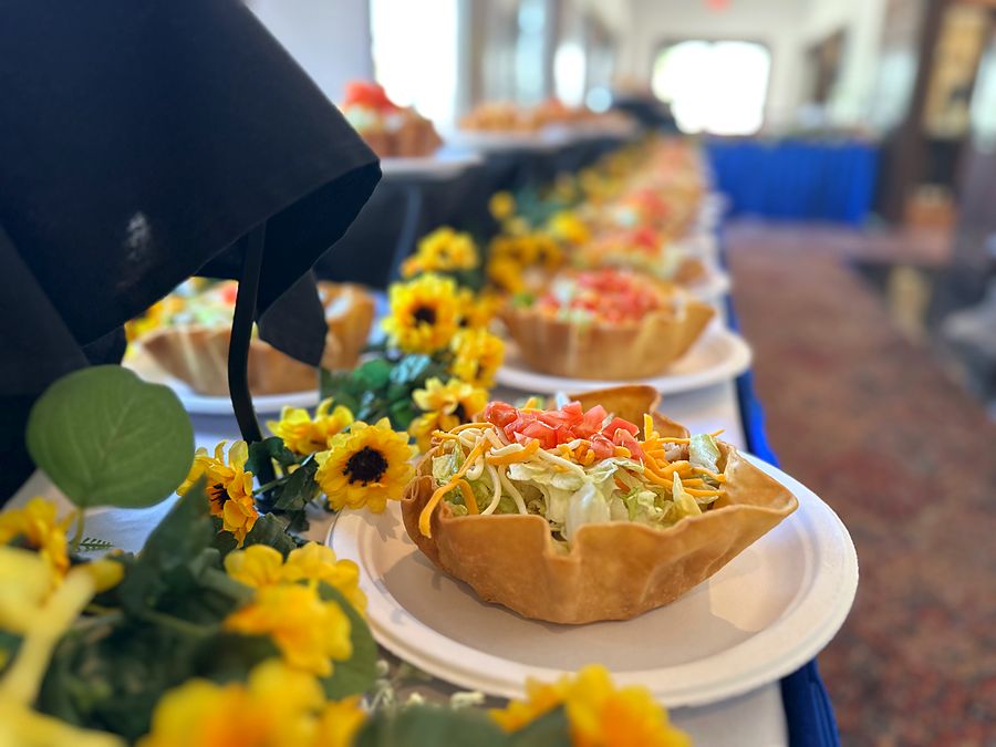Taco salads lined up at a catered event
